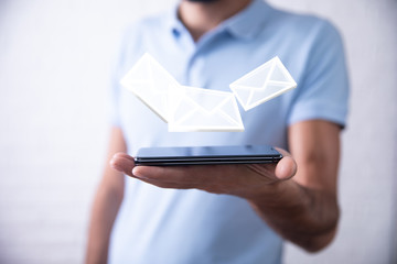 Businessman hand phone with email icon in screen