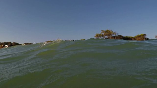 Shooting from sea, sunset and waves cover camera. Portugal Algarve.