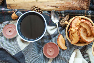 Autumn atmospheric composition of the home layout.Box from the vines, bumps, candles, cup of tea, autumn decor, wooden board and textiles.