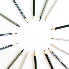 Round frame of pencils on white background. Flat lay, top view minimal concept.
