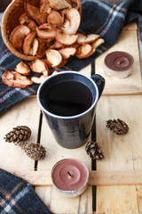 Autumn atmospheric composition of the home layout.Box from the vines, bumps, candles, cup of tea, autumn decor, wooden board and textiles.