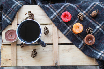 Autumn atmospheric composition of the home layout.Box from the vines, bumps, candles, cup of tea, autumn decor, wooden board and textiles.