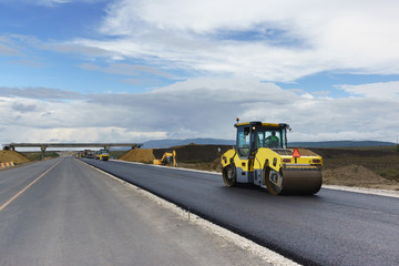 Laying the next layer of asphalt in the construction of a new road Tavrida in the Crimea. The...