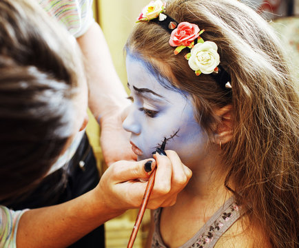 little cute child making facepaint on birthday party, zombie Apo
