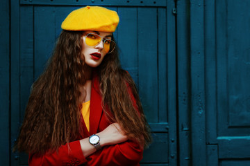 Outdoor waist up fashion portrait of young beautiful fashionable woman wearing stylish yellow...