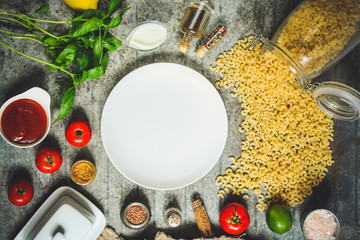 pasta with tomato sauce (set of ingredients) on the table. top view. food background
