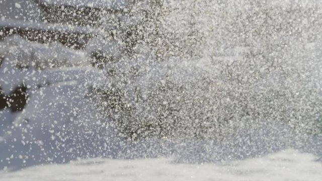 Loop of SLOW MOTION: Throwing snow up in the air