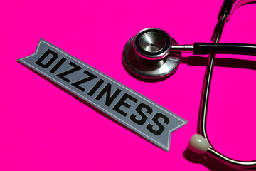 Dizziness on the paper with medicare Concept Inspiration. Stethoscope on pink bakcground 