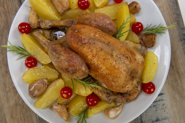 Roast chicken and various vegetables on a white plate