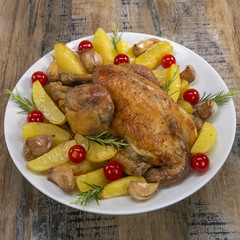 Roast chicken and various vegetables on a white plate