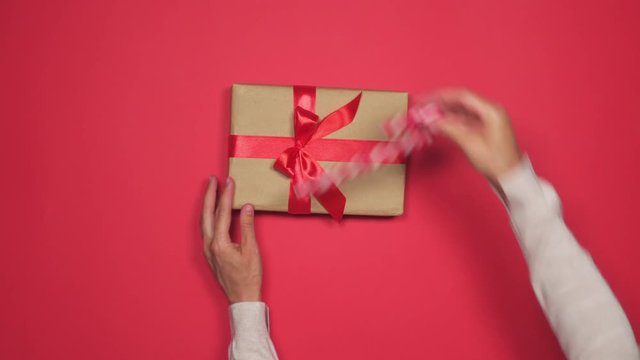 Hands placing lollipop to Christmas gift box