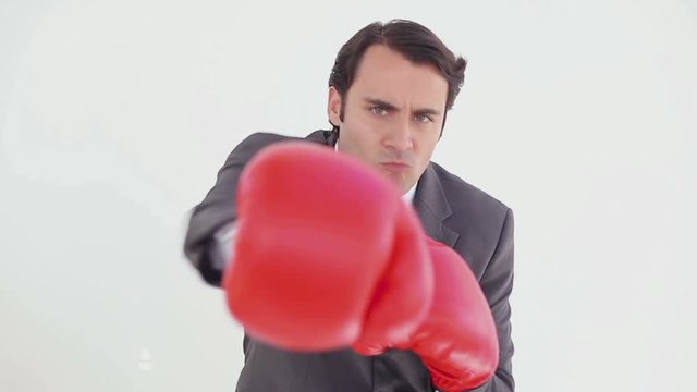 Loop of Serious man using boxing gloves