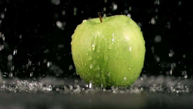 Loop of Water raining on an apple in super slow motion