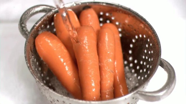 Loop of Carrots being washed in super slow motion