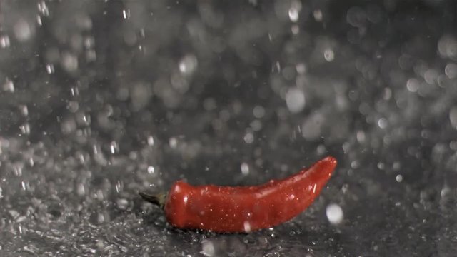 Loop of Water raining on chili in super slow motion