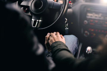 hands of lovers in the new modern car.