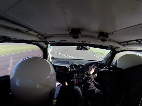 Footage of inside a rally car racing and driver almost loses control on a bend.