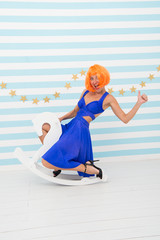 Crazy woman ride horse toy. Woman rider ride horse like crazy. Just like a kid. work hard play hard. Carefree beauty. happy woman spending carefree time on her own.