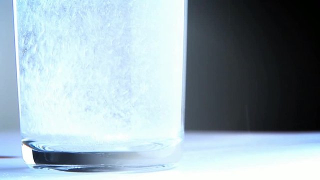 Loop Of Fizzing Alkaseltzer In Glass Of Water