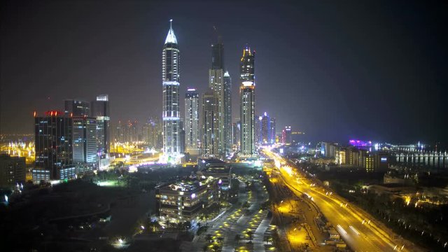 Loop of Elevated illuminated night view of Media and Internet city, Dubai, UAE, Time Lapse