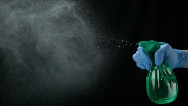 Loop of Using spraying bottle and cleaning on black background shooting with high speed camera, phantom flex.