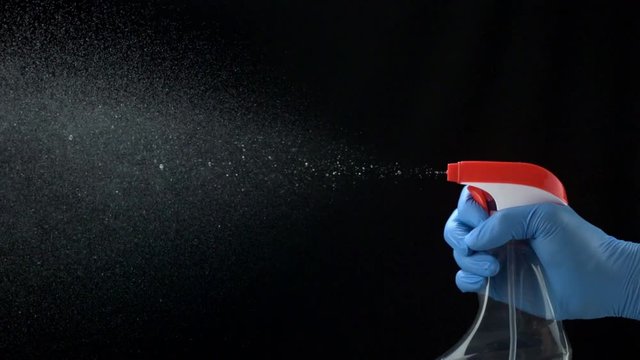 Loop of Using spraying bottle and cleaning on black background shooting with high speed camera, phantom flex.