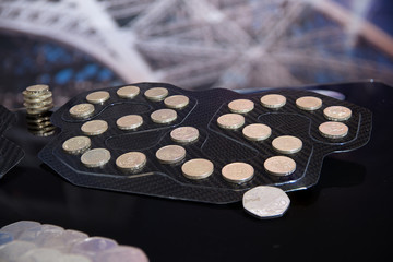 Old British one pound coins collection in the carbon fibre tray.