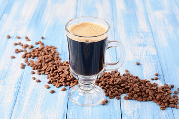 Irish coffee on a blue wooden background with coffee beans