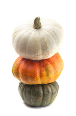 Three Colors of Pumpkins Stacked on a White Background