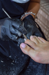 .The master makes a hardware pedicure in the studio