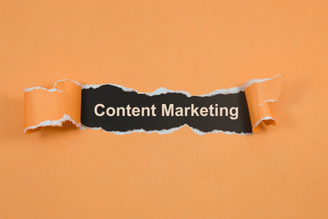 Content Marketing text on paper. Word Content Marketing on torn paper. Concept Image.