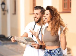 Naklejka premium A pair of happy young tourists sightseeing in summer