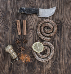 cooking fried sausages on a kitchen wooden table