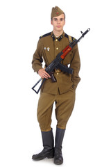 A soldier in military uniform of soviet army stay and hold Kalashnikov rifle with one hand in pocket