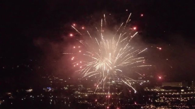 Loop of AERIAL SLOW MOTION: Fireworks above the city