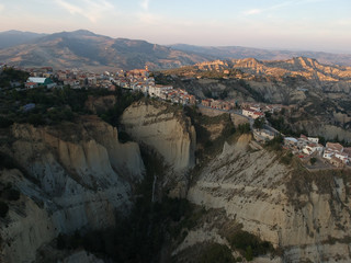 Fototapeta premium view of Aliano, a town in the province of Matera, in the Southern Italian region of Basilicata, Italy. Famous for the typical calanchi landscape. Aerial view