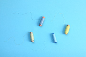 Colored thread on a blue background