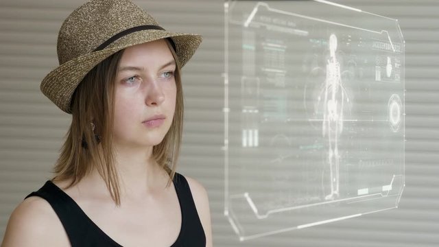 Young girl press on futuristic user interface concept screen. Graphical User Interface - GUI. Head up Display - HUD. Internet of things.