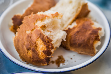 Close up pieces of bread in white bowl. Cafe bar