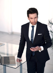 Fototapeta premium confident businessman standing in the office