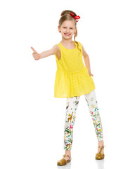 Little girl holding her thumb up