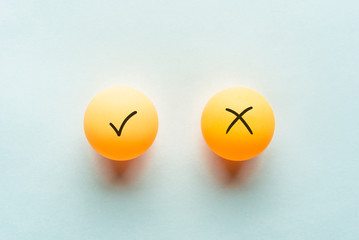 Check mark concept, yes or no dilemma concept with ping pong balls.