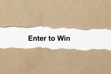 Enter to win text on paper. Word Enter to win on torn paper. Concept Image.
