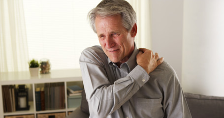 Elderly caucasian man with neck and shoulder pain