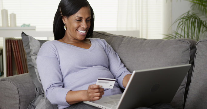 Middle Aged Woman Using Laptop To Pay Bills