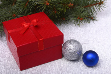 Christmas fir tree with gift box on wooden board