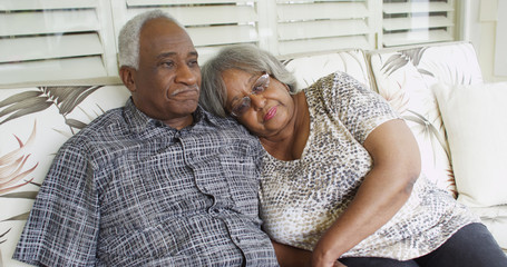 Senior African couple relaxing on a couch
