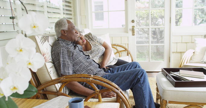 Happy elderly African couple sitting on a couch