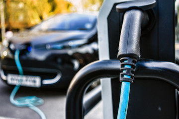 Fototapeta na wymiar Electric car is changing on street parking in UK