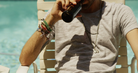 Mexican man sunbathing by the pool